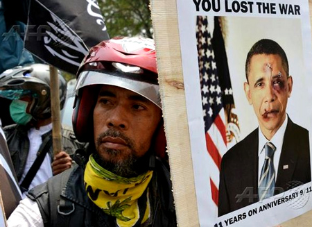 Indonesian protester holds picture of a disfigured Obama at an anti-US demo in Jakarta (the Muslim country Obama grew up in.)  