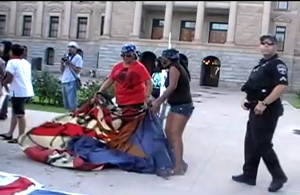 Police Watch as SB1070 Illegal alien supporters desecrate US Flag during National Anthem.  